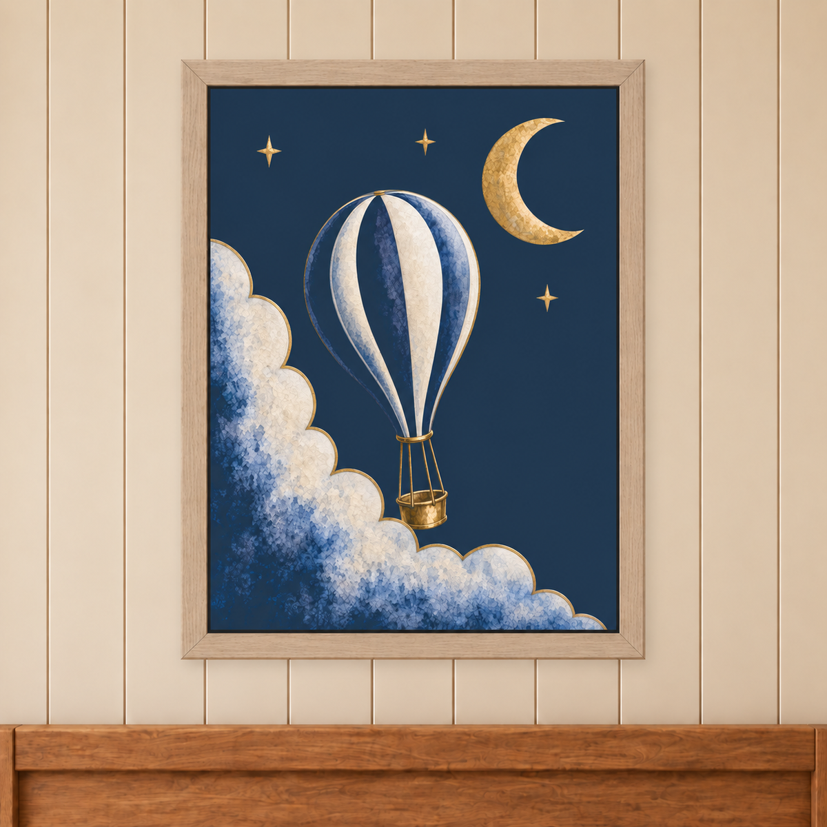 Moonrise Balloon and Crescent Print in a natural wood frame above a timber bed headboard on a cream panelled wall.