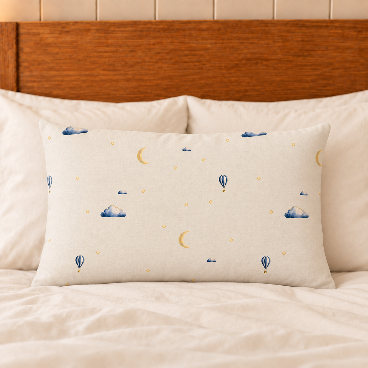 Moonrise filled lumbar cushion with printed front on plain ivory bedding.