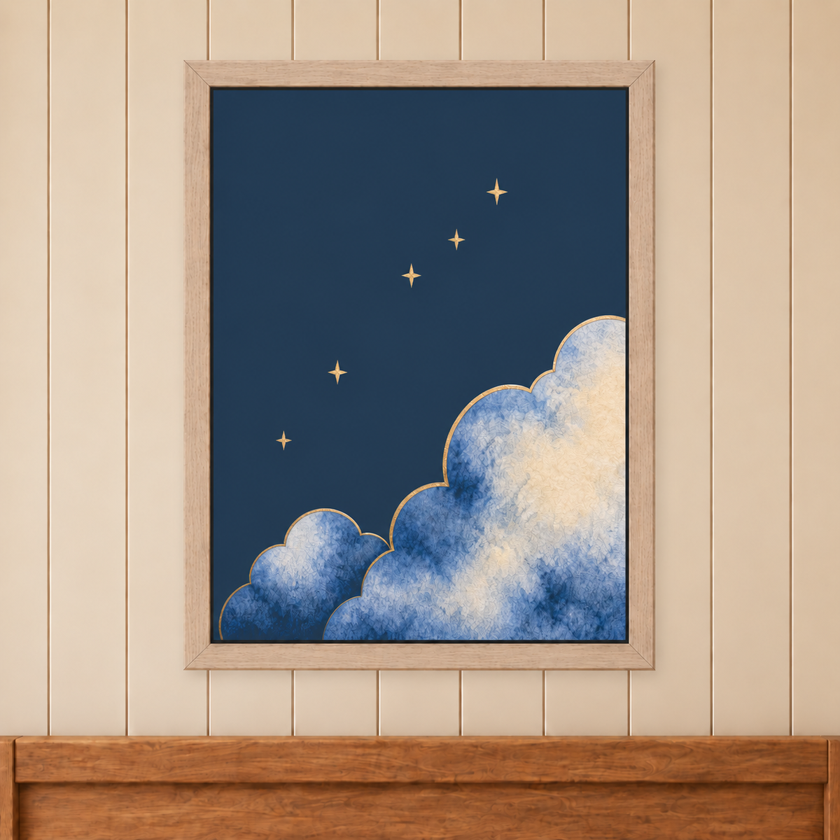 Moonrise Clouds and Stars Print in a natural wood frame above a timber bed headboard on a cream panelled wall.
