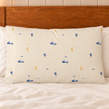 One Moonrise standard pillowcase with printed front on a bed with plain ivory bedding.