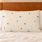 One Moonrise standard pillowcase with printed front on a bed with plain ivory bedding.