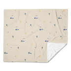 Printed Moonrise throw shown flat with a folded corner revealing its plain white reverse.