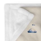 Close view of the plain white reverse and printed front edge of the Moonrise throw.